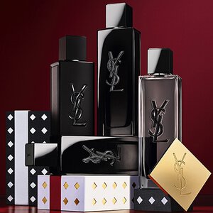 Coffrets cadeaux de la collection de fetes Yves Saint Laurent et produits de beaute de luxe sur fond rouge festif.