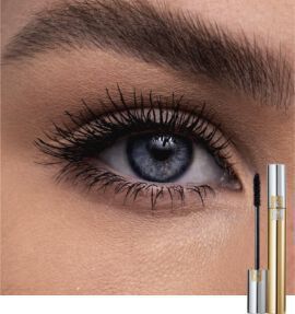 Close-up of a blue eye with long, defined eyelashes, alongside a tube of mascara.