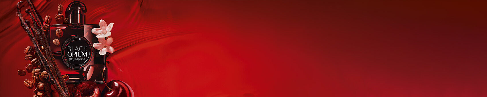 Black Opium perfume bottle surrounded by vanilla, coffee beans, jasmine, and cherries on a red background