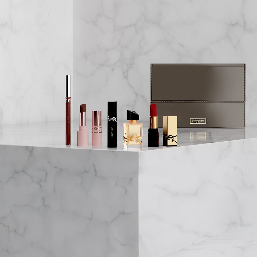 YSL Beauty-Set mit Miniprodukten und weißer Kosmetiktasche.