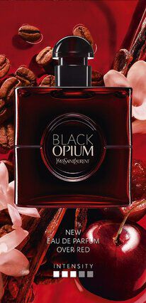 A bottle of Black Opium Eau de Parfum by Yves Saint Laurent on a vibrant red background, surrounded by coffee beans and pink flowers.