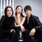 A group of three stylish models poses together in a minimalist setting. They convey a sense of confidence and fashion, with the logo "YSL BEAUTY CLUB" featured prominently at the bottom.