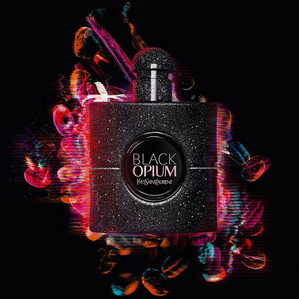 A sleek black perfume bottle with a glittery finish, featuring the label "Black Opium" by Yves Saint Laurent, set against a vibrant, abstract background of colorful swirls and patterns.