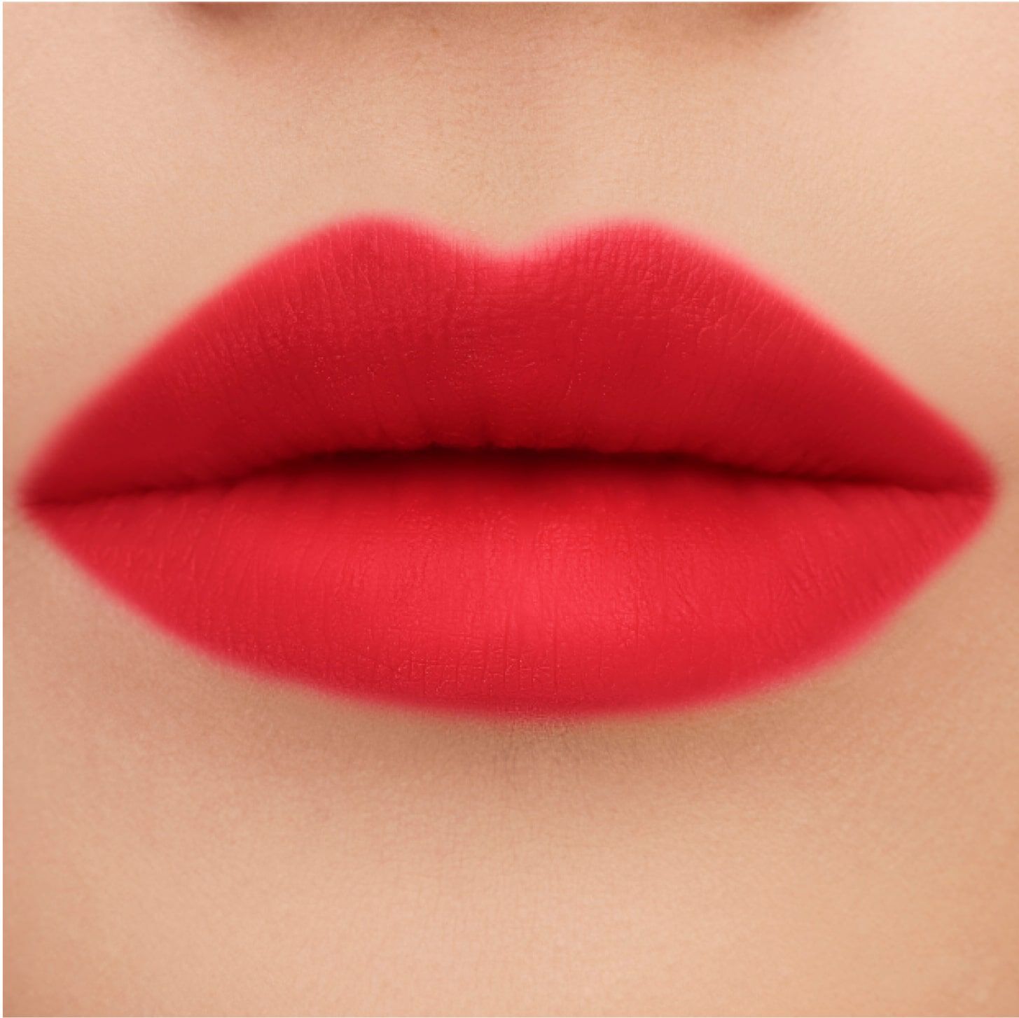 Close-up of smooth, full lips painted in a vibrant red matte lipstick.