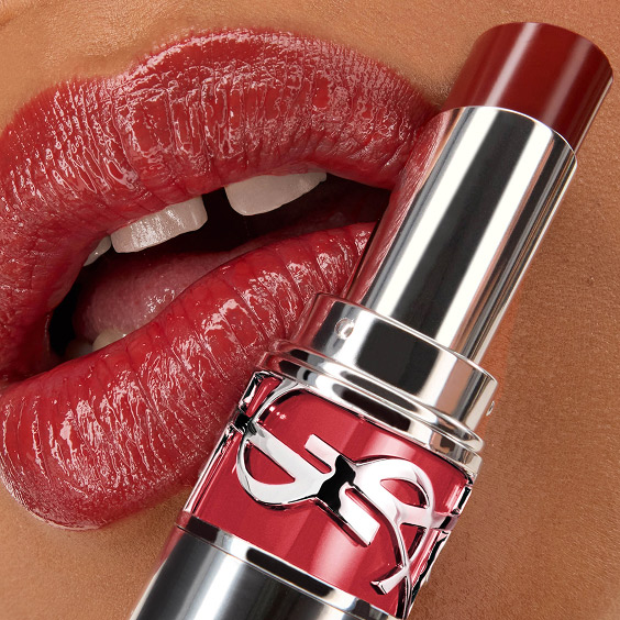 Close-up of Mawena's lips wearing YSL LOVESHINE Lipstick in shade 219 Berry Crush, with the lipstick tube in the foreground.