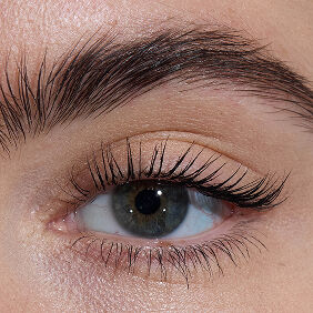 Close-up of an eye with light skin tone, showcasing lengthened lashes from YSL Lash Latex Mascara with level two intensity.