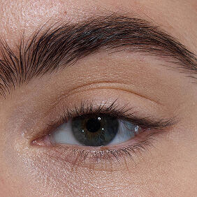 Close-up of an eye with light skin tone, showcasing bare lashes.